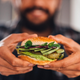 Man holding vegan chickpea burger